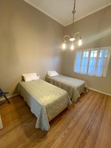 a room with two beds and a window at Casa 1936 in Suipacha