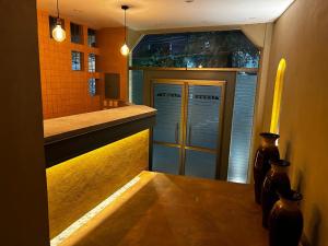 a kitchen with a counter with two doors and vases at Hotel Arcadia Cuernavaca in Cuernavaca