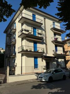 a white car parked in front of a building at Verona green harmony in Verona