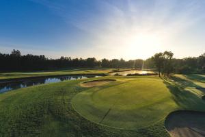 an aerial view of a golf course with a pond at Blue Haven Retreat - Glenmore Park Pool Home in Glenmore Park