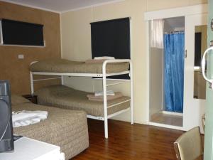 a small room with two bunk beds in it at Roma Aussie Tourist Park in Roma