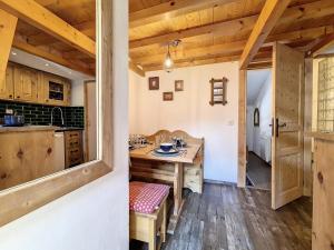 a kitchen with a wooden table and a dining room at Résidence Biolley - Appartement moderne mansardé · Au pied des pistes · Centre village MAE-1664 in Saint-Martin-de-Belleville +8 photos