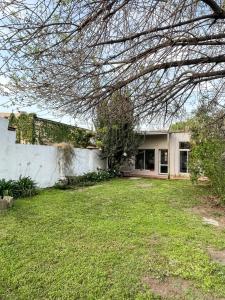 a house with a yard in front of it at Casa 1936 in Suipacha