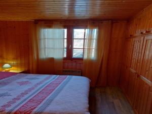 a bedroom with a bed and a window at Chalet in Vosges near Rouge Gazon Ski Resort in Saint-Maurice-sur-Moselle