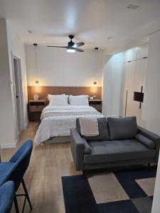 a large bedroom with a bed and a couch at Villa Topenga Deluxe Studio in Richards Pen