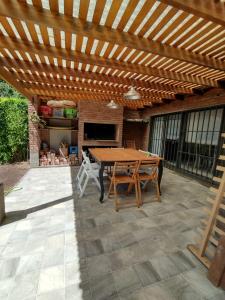 ヴィラ・カルロス・パスにあるCasa Privada Carlos Paz con piscina a dos cuadras del rioの木製パーゴラ(木製テーブル付) +17枚の写真