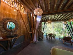 una stanza con pareti di legno, uno specchio e un tavolo di Eco Bamboo Island Bali - Bamboo House #2 a Selat