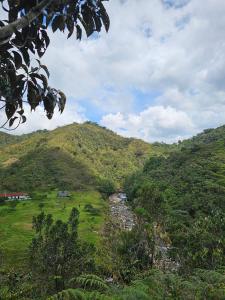 a view of a mountain with a river in a field at Reserva Natural Maimará in Alejandría