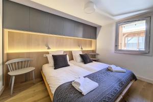 En eller flere senge i et værelse på Résidence Caseblanche - Chalet La Retreat MAE-2984