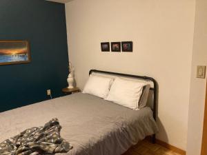 a bedroom with a bed and two pictures on the wall at Hidden Creek Hideaway in Roberts Creek
