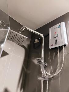 a shower in the corner of a bathroom at Staycation by Ness in Ayala Makati in Manila