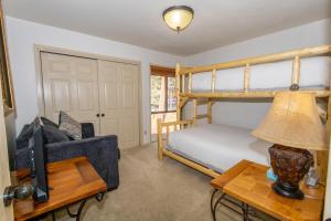 a bedroom with a bunk bed and a couch at Wild Irishman 1041A in Keystone +19 photos