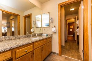 a bathroom with a sink and a large mirror at Willows 1713 in Keystone +23 photos