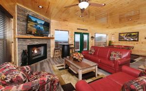 a living room with red furniture and a fireplace at A Splash of Heaven in Pigeon Forge