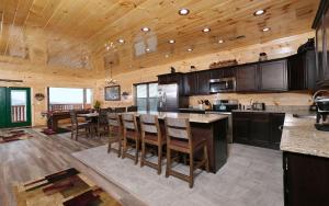 a large kitchen with wooden ceilings and a table and chairs at A Splash of Heaven in Pigeon Forge