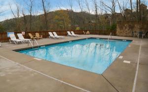 a large swimming pool with chairs at A Splash of Heaven in Pigeon Forge