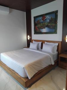 Postel nebo postele na pokoji v ubytování Sujiwa Ubud Hotel & Villa