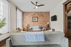 a living room with a couch and a ceiling fan at 3-BR Historic Home Nestled Btw Petworth & CoHi in Washington, D.C.