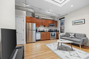 a kitchen and living room with a couch and a table at Logan Circle Carriage House 1b-1b Central & Bright in Washington, D.C.