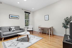 a living room with a couch and a table at Logan Circle Carriage House 1b-1b Central & Bright in Washington, D.C.