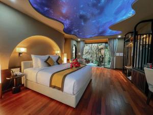 a bedroom with a large bed with a star ceiling at Lamori Resort & Spa, Thanh Hoá in Thanh Hóa