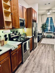 a kitchen with a stove and a refrigerator at Close to Everything in Downtown King bed Free Onsite Parking and WiFi in Houston
