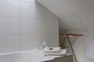 a room with white walls and a table with towels at La Maison Saint-Amour in Chanaleilles +61 photos