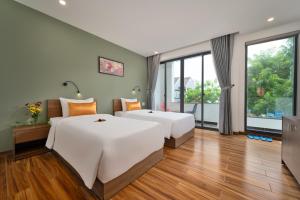 Postel nebo postele na pokoji v ubytování Hoi An January Villa + 37 fotografií