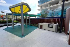 a yellow structure on a patio next to a building at Sunsuria Forum - Azumi Homes in Setia Alam +8 photos
