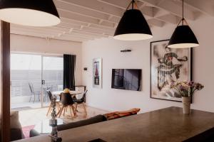 a living room with white walls and black lights at Boutique Warehouse living in West Hobart in Hobart