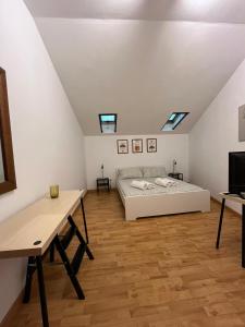 a attic bedroom with a bed and a desk at Fikus APT relax Castello Ursino in Catania +39 photos