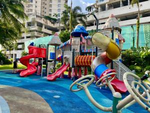 a playground in a park with a slide at Country Garden Danga Bay,Full Seaview, 6-8pax, Netflix in Johor Bahru