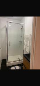 a bathroom with a shower with a glass door at Villa Tenjin Chambre 15 in Bondy +22 photos