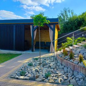 una casa con un árbol en medio de un patio en Domek w dolinie, en Berest
