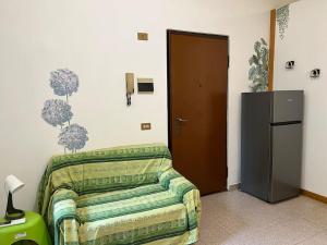a room with a bed and a refrigerator in it at La tana moderna in Piacenza