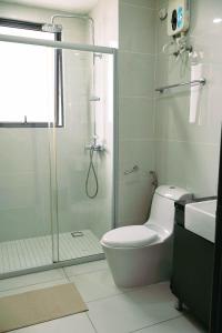 a bathroom with a shower and a toilet and a sink at Country Garden Danga Bay,Full Seaview, 6-8pax, Netflix in Johor Bahru