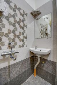 a bathroom with a sink and a mirror at IT'S HOME in Aurangabad