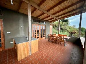 a kitchen and dining area of a house with a patio at Jua Zuri in Lushoto