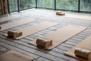 a room with four yoga mats on the floor at Pytloun Wellness Hotel Harrachov in Harrachov