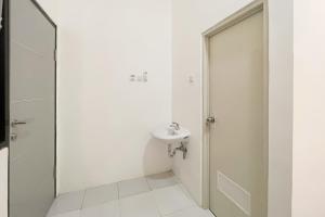a white bathroom with a sink and a shower at RedDoorz at Pandu Raya Bogor by Madam M Place in Kalibata 1 +16 photos