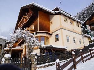 a house with a fence in the snow at Apartment in Hippach with Mountain Views in Hippach