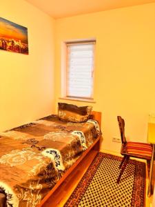 a bedroom with a bed and a window and a chair at Donea Home Service in Schönebeck