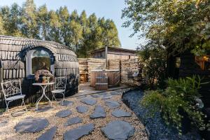 a backyard with a yurt with a table and chairs at La CABANE LUXUEUSE AVEC JACUZY in Lavacherie