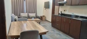 a kitchen and living room with a table and a couch at Tanger Tower in Manama