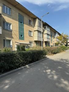 an apartment building with a street light next to a road at Apartment in Airport in (( Turksib ))