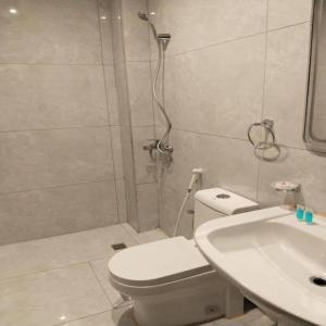 a bathroom with a shower and a toilet and a sink at Etlalat Obhur in Jeddah