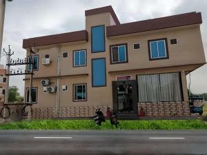 a house with blue windows on the side of a street at Hotel Prem Bhawan in Khātu