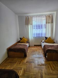 una habitación con dos camas y una ventana en Hostel kamelarny dla seniorow z celodobowa opieka Wera, en Ząbki 16 fotos más