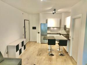 a kitchen with a table and chairs in a room at Venezia Home in Rovereto