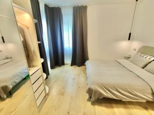 a small bedroom with a mirror and a bed at Venezia Home in Rovereto